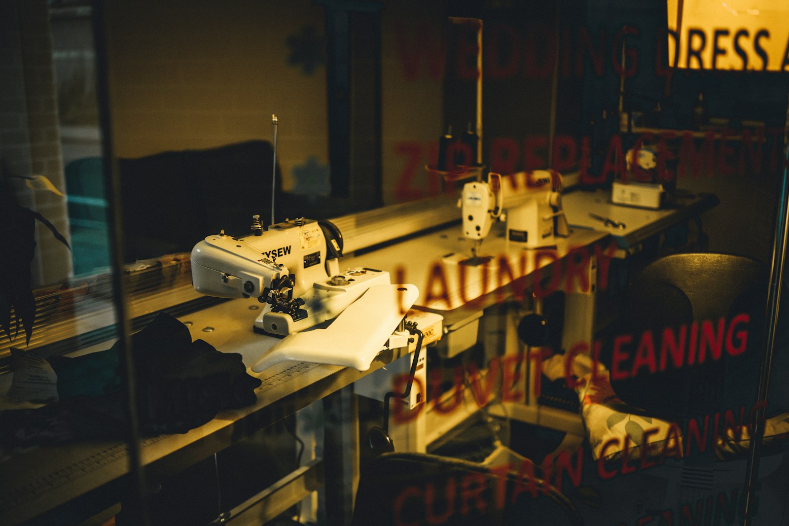 Sewing machine on a workshop table at dim light